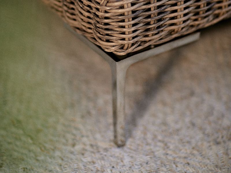 Detail shot of Outer's All-Weather Wicker outdoor furniture and the stainless steel leg